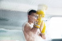 Boxer homem em luvas amarelas de pé no ringue e se sentindo mal durante a luta. — Fotografia de Stock