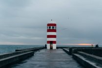Old red and white colored lighthouse at ocean, Porto, Portugal — Stock Photo