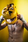 Shirtless boxer man putting on helmet for the fighting. — Stock Photo