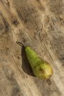 Fresh green pear on wooden surface — Stock Photo