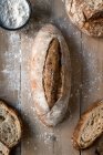 Pão de centeio coberto de farinha na mesa de madeira — Fotografia de Stock