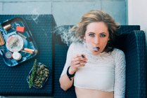 Giovane donna che fuma una canna da cannabis — Foto stock