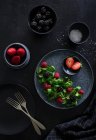Berries salad on a dark atmosphere — Stock Photo