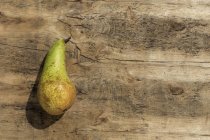 Fresh green pear on wooden surface — Stock Photo