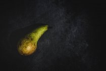 Fresh green pear on black background — Stock Photo