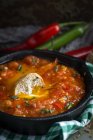 Жареное яйцо с помидорами и красным и зеленым перцем в сковороде — стоковое фото