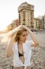Herrliche Frau steht am Strand — Stockfoto