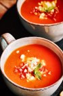 Tomato gazpacho served with egg and ham in cups — Stock Photo
