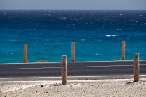 Road and blue ocean water on Canary islands — Stock Photo