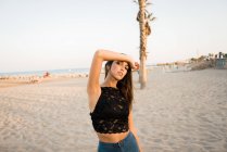 Magnifique femme brune posant sur la plage — Photo de stock