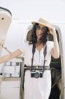 Smiling female traveler with photo camera departing from plane on arrival at airport — Stock Photo