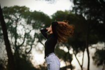 Slim young lady in park — Stock Photo