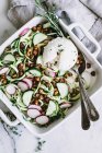 Zucchini salad in patterned dish with spoon — Stock Photo