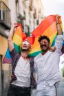 Couple boys with gay pride flag on the street of Madrid city — Stock Photo