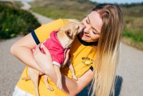 Girl with small Chihuahua in sunlight — Stock Photo