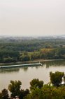 BRATISLAVA, SLOVAKIA, OCTOBER 2, 2016: boat sailing on Danube river and skyline — Stock Photo