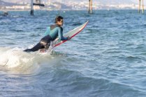 Молодий чоловік серфінг хвиля на своїй дошці — стокове фото