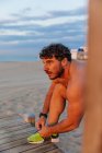 Scarpa runner legante sulla spiaggia sabbiosa al tramonto — Foto stock