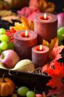 Composição de queda para Ação de Graças com velas, folhas de outono, uvas, abóboras e sementes de milho — Fotografia de Stock