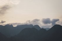 Silhouette of mountains and cloudy sky — Stock Photo