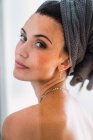 Portrait of young topless woman with towel on head turning around and looking at camera — Stock Photo