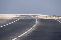 Autopista que atraviesa el árido desierto de Fuerteventura, Islas Canarias - foto de stock