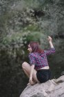 Red haired girl rests by the river — Stock Photo