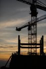 Silhouette of construction site on sunset background — Stock Photo