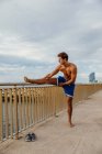 Male athlete doing stretching outside — Stock Photo