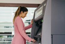 Young elegant woman using ATM machine — Stock Photo