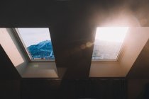 Vista delle montagne attraverso la finestra della mansarda — Foto stock