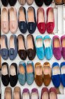 Shoes at stand, Typical arabic architecture in Asilah. Streets, doors, windows, shops. Morocco — Stock Photo
