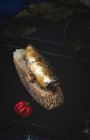 Pequeño pimiento rojo cerca del pan con pescado enlatado en la sartén - foto de stock