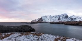 View of snowy peaks of mountains on shore of Lofoten island in gloomy cloudy day, Norway — Stock Photo