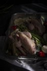 Raw whole chickens ready to roast on baking pan with ingredients — Stock Photo