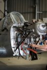 Руки самолета механической фиксации двигателя маленького самолета в ангаре — стоковое фото