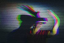 Man testing VR glasses on dark background — Stock Photo