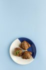 Croissant al forno su placca bianca e blu su fondo blu — Foto stock