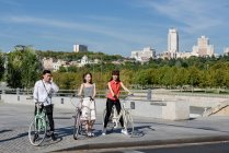 Asian people with bicycles — Stock Photo