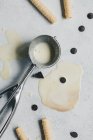 Melted vanilla ice cream in silver spoon — Stock Photo