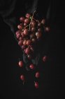 Bunch of fresh red grapes on black background — Stock Photo