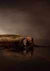 Arched cliff located near calm sea at night in nature, Asturias, Spain — Stock Photo