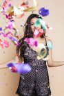 Portrait of happy young woman in festive dress with streamers — Stock Photo
