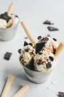 Ванільне морозиво з шоколадом і вафлями у маленькому відрі на білому столі — стокове фото