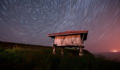 Magnífico céu estrelado sobre pequena cabana na natureza à noite, Astúrias, Espanha — Fotografia de Stock