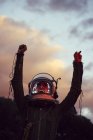 Girl wearing old space helmet and costume at sunset — Stock Photo