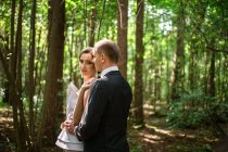 Married couple looking at each other in forest — Stock Photo