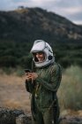 Beautiful female astronaut with mobile phone. — Stock Photo