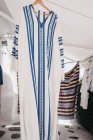 Different traditional tunics on cloth hangers at street market, Mykonos, Greece — Stock Photo