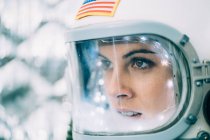 Beautiful woman poses dressed as an astronaut. — Stock Photo